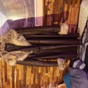 A Olsen Vintage Leather Jacket with fur trim on the collar and arms.